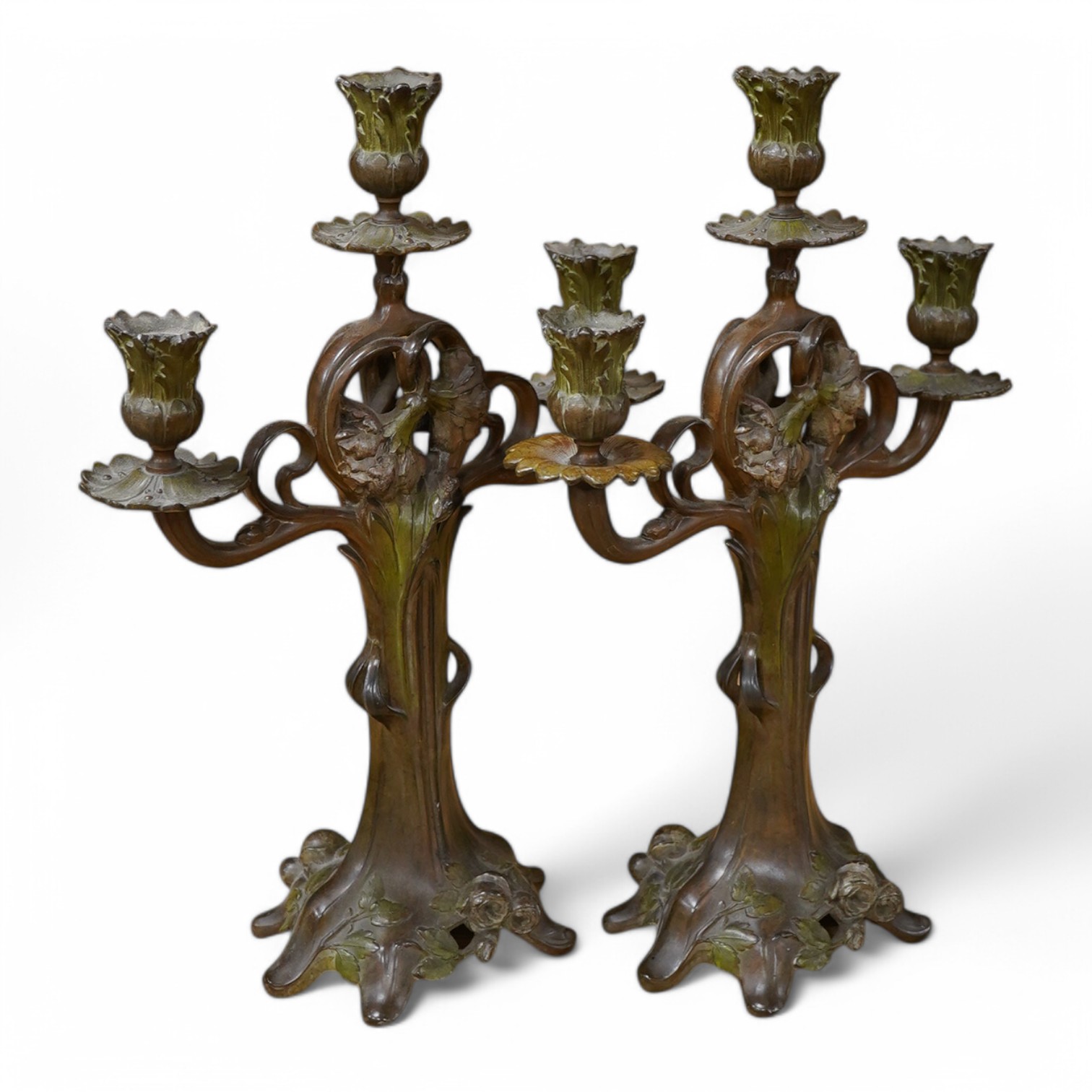 A pair of French patinated spelter floral painted Art Nouveau two branch, three light candelabra, 40cm high. Condition - good